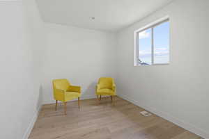 Living area with light hardwood / wood-style flooring
