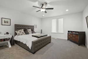 Carpeted bedroom with ceiling fan