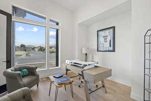 Home office with light wood-type flooring