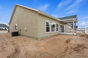 Back of house featuring a patio and central AC unit. LANDSCAPING COMING!