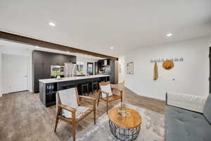 Living room with sink and light hardwood / wood-style floors