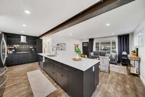 Kitchen with a spacious island, steel beam, and sink.