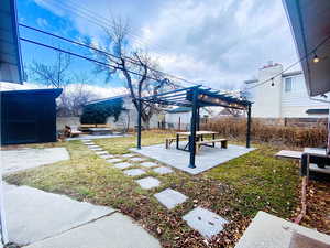 Entertainer's backyard with a fire pit, a gazebo, a pergola, and a patio area.