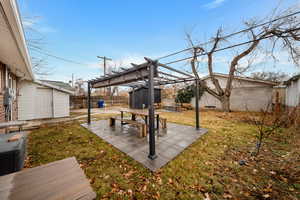 View of yard with a shed, a pergola, and a patio area