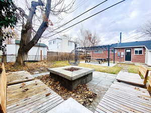 Fire pit with wooden benches. Round swing.