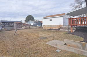 View of yard with a wooden deck