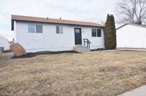 Ranch-style home with a front yard