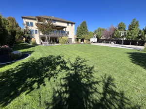 View of yard featuring a balcony and a patio