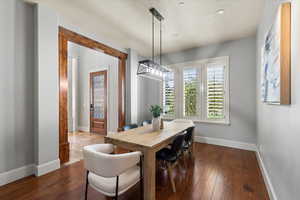 Dining room with dark hardwood / wood-style floors