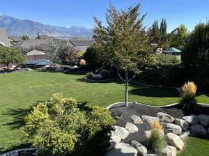 View of yard with a mountain view and a trampoline