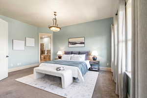 Carpeted bedroom featuring connected bathroom