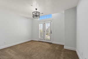 Carpeted bedroom featuring a notable chandelier