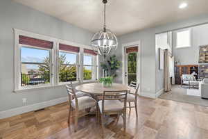 Dining area featuring an inviting chandelier, a mountain view, and light hardwood / wood-style floors