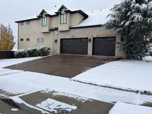 View of heated driveway and garage