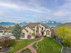 French provincial home featuring a mountain view and a front lawn