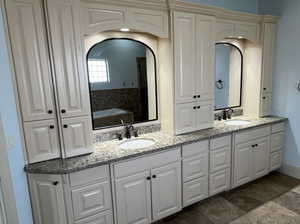 Bathroom with vanity and a tub