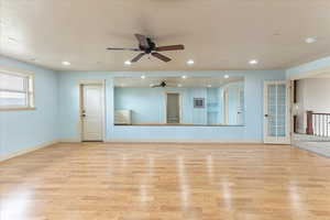 Dance studio featuring ceiling fan, light hardwood / wood-style floors, and french doors