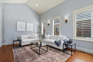 Living room featuring vaulted ceiling and hardwood / wood-style floors