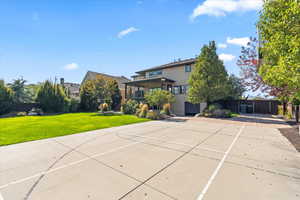 View of basketball court with a lawn