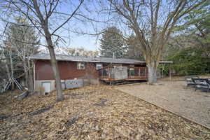 Back of property featuring a wooden deck