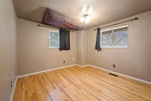 Spare room with hardwood / wood-style flooring and a textured ceiling