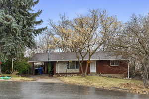 Single story home featuring a carport