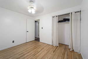 Unfurnished bedroom with light hardwood / wood-style floors, a closet, and ceiling fan