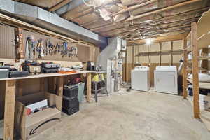 Basement with a workshop area and washer and dryer