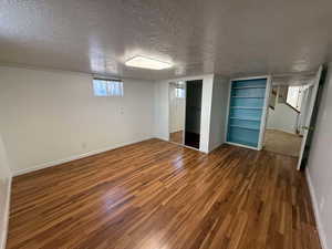 Unfurnished bedroom featuring a closet, hardwood / wood-style floors, and a textured ceiling