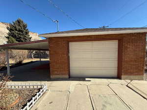 Garage featuring a carport