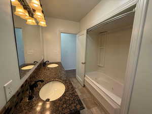 Bathroom featuring vanity and shower / tub combination