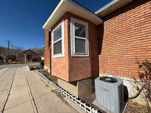 View of side of home with central AC