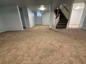 Basement with a textured ceiling and carpet flooring