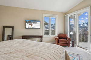 Bedroom featuring carpet flooring, a mountain view, access to outside, and vaulted ceiling