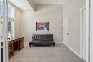 Sitting room featuring light colored carpet