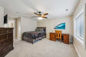 Bedroom with light carpet and ceiling fan