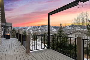 Snow covered deck with a mountain view