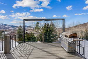 Wooden terrace with a mountain view and grilling area