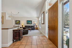 Foyer entrance with a healthy amount of sunlight and light tile patterned floors