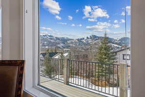 Snow covered back of property featuring a mountain view