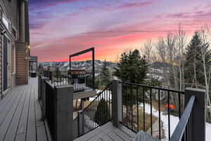 Snow covered deck featuring a mountain view