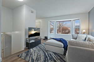 Living room with hardwood / wood-style flooring