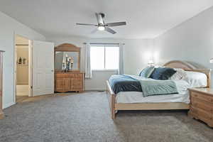 Carpeted bedroom featuring ceiling fan