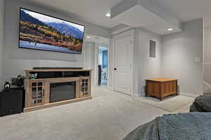 Bedroom featuring light colored carpet and electric panel