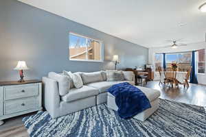 Living room featuring hardwood / wood-style flooring and ceiling fan