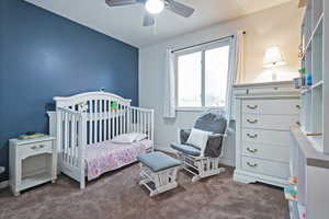 Bedroom featuring ceiling fan and carpet floors