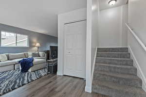 Stairs featuring hardwood / wood-style floors