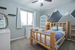 Bedroom featuring ceiling fan and carpet