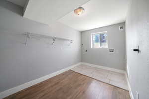 Washroom featuring electric dryer hookup, washer hookup, and light hardwood / wood-style floors