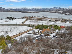 Snowy aerial view with a water and mountain view